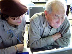 高齢者にパソコン指導風景